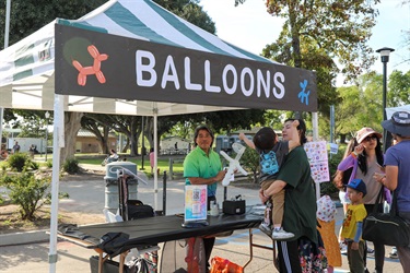 Man making balloon animals for children