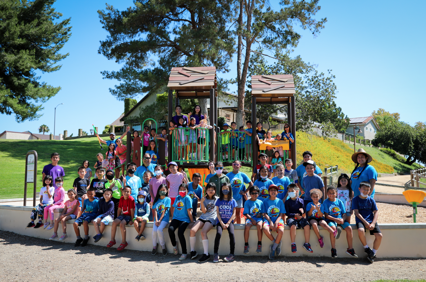Group picture of children and staff on the playground at Lemon Creek Park