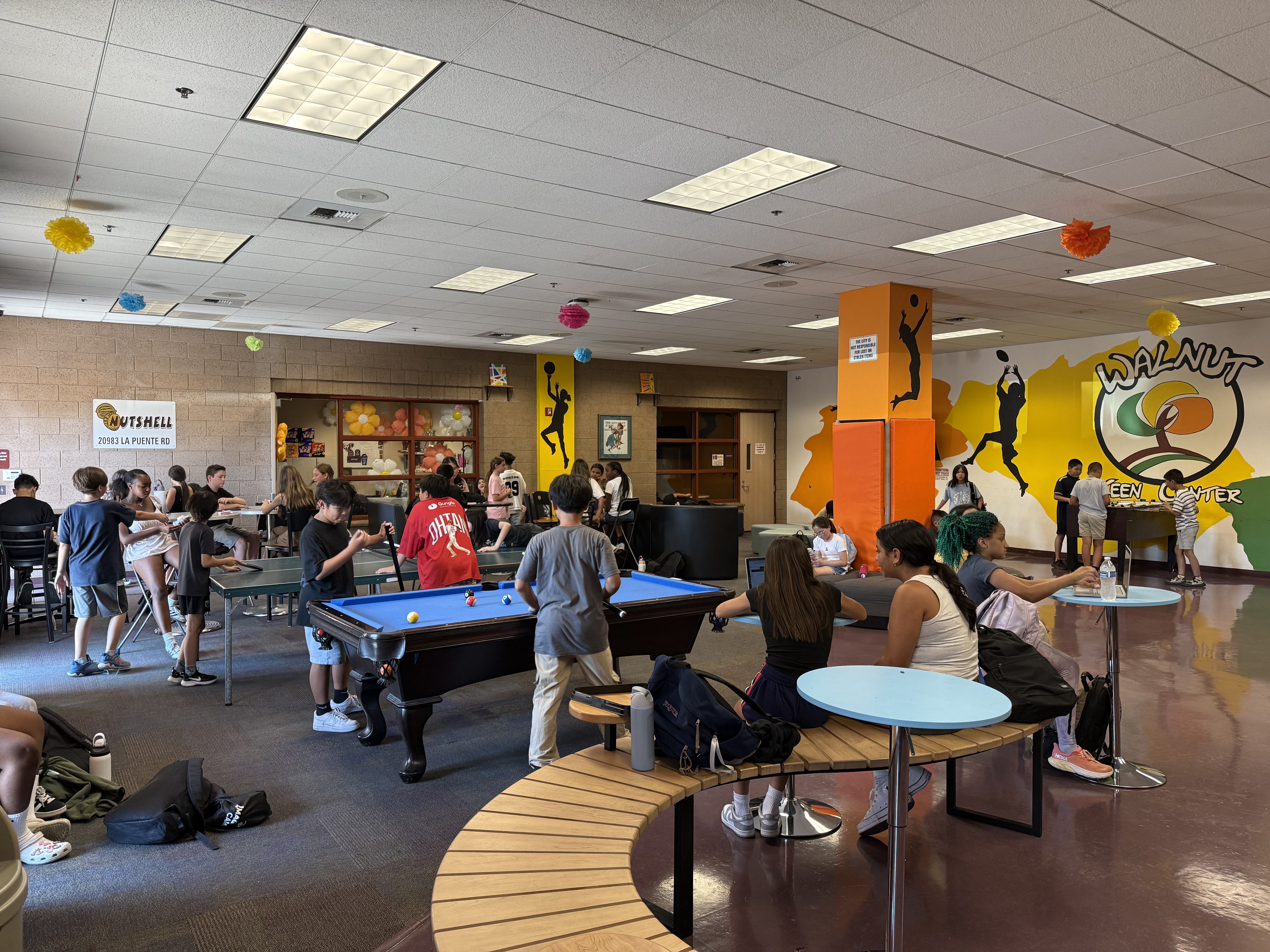 Teens inside of the Walnut Teen Center enjoying amenities