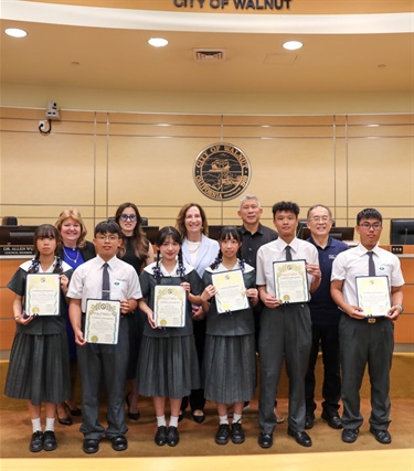 City Council members presenting certificates to students in the Council Chambers