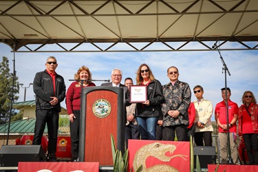 City council members on stage receiving a certificate during Lunar New Year